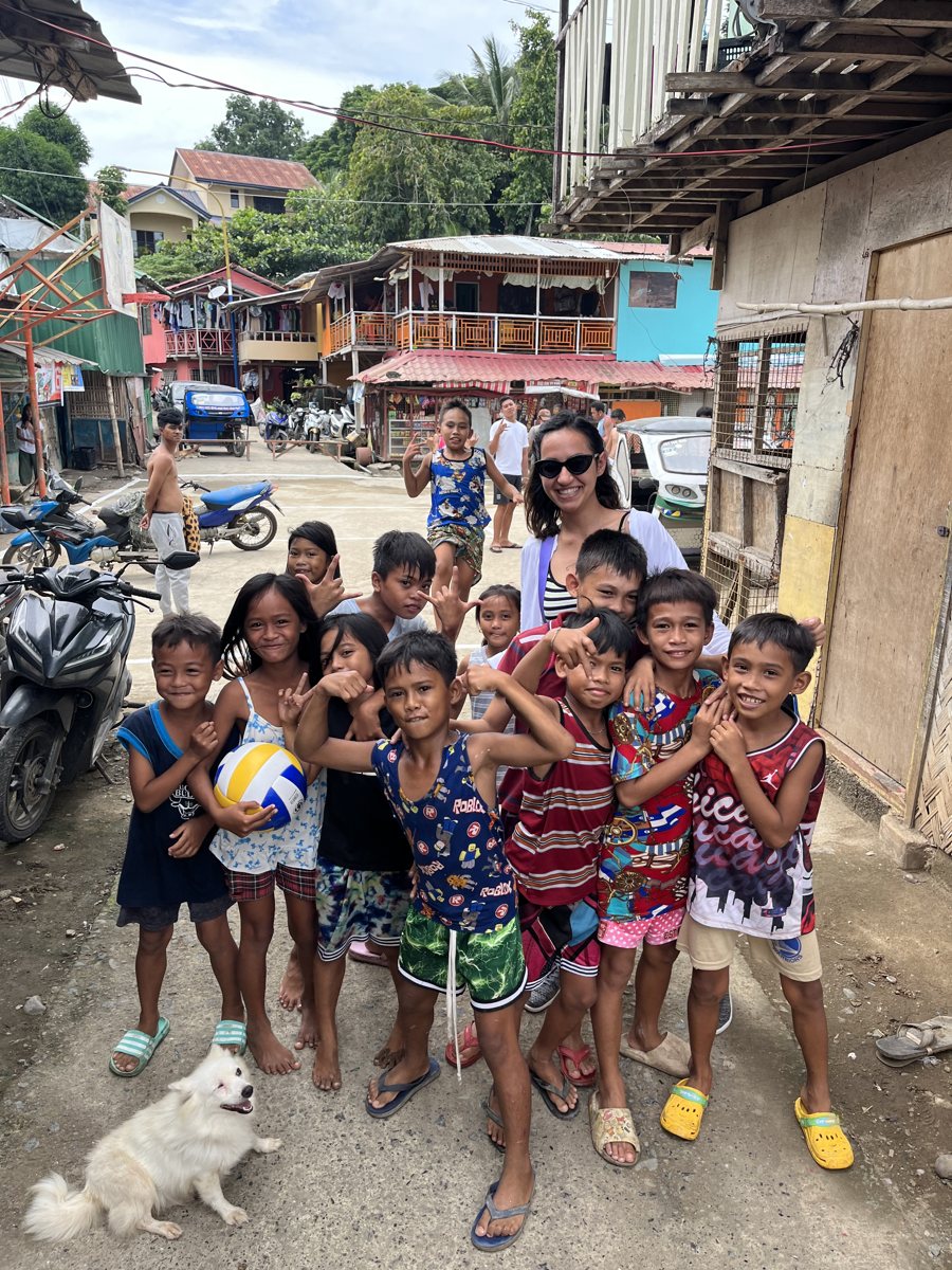 Fatemeh Naderi with children in a Cebu neighborhood