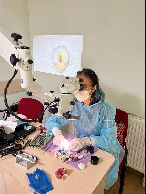 Fatemeh Naderi training on an operating microscope